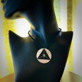 This photo shows a triangle disc pendant hand carved from ebony with nz paua shell, Mother of Pearl alongside; brass and silver. This is a stand out one off necklace for those who appreciate art to wear. It is provided with a cord in black that is a fixed length with Paua Shell Toggle. We ship this piece worldwide and shipping is included in the price.
